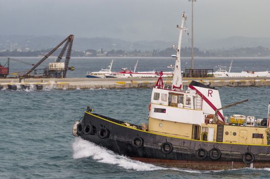 tow floats among the waves in the harbor in windy weather