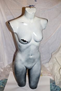 grey mannequin full female torso in an artist studio