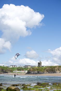 lone kite surfer riding with the waves at ballybunion beach on the wild atlantic way