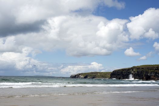 lone kite surfer surfing the waves at ballybunion beach on the wild atlantic way