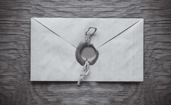 envelope with a stamp on the wooden background
