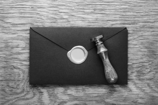 envelope with a stamp on the wooden background