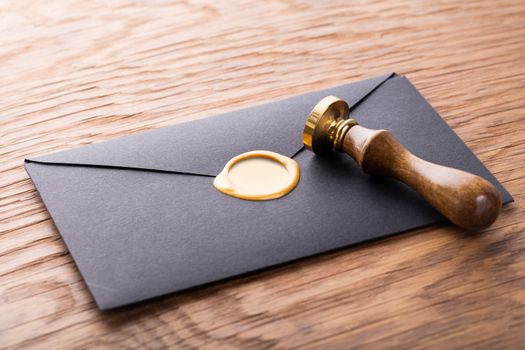 envelope with a stamp on the wooden background