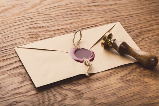 envelope with a stamp on the wooden background