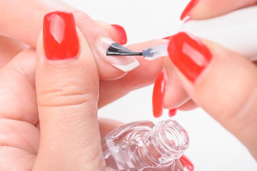 Manicure, covreing nails with transparent painting polish