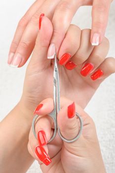 Nail salon, hands beauty treatment, cuticles cutting with scissors