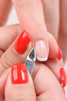 Nail salon, hands beauty treatment, cuticles cutting with nail clippers