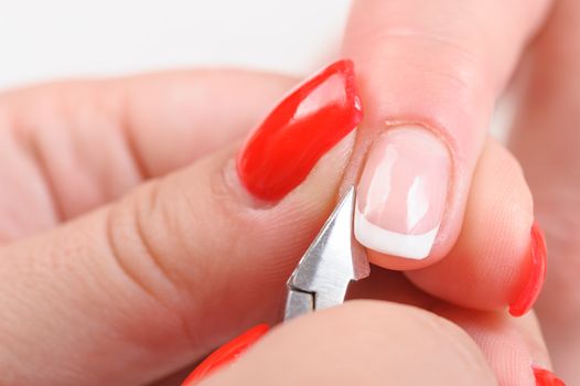 Nail salon, hands beauty treatment, cuticles cutting with nail clippers