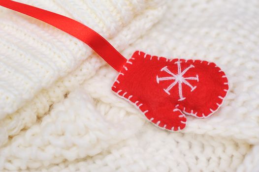 white texture knitted scarf and hat with a red mitten.