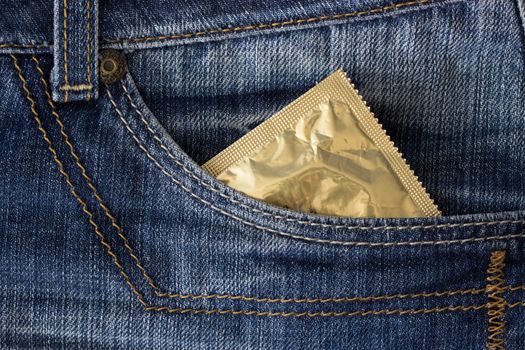 condom in a pocket of blue jeans