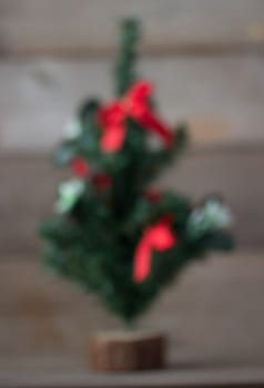 blured Christmas tree with red decorations background