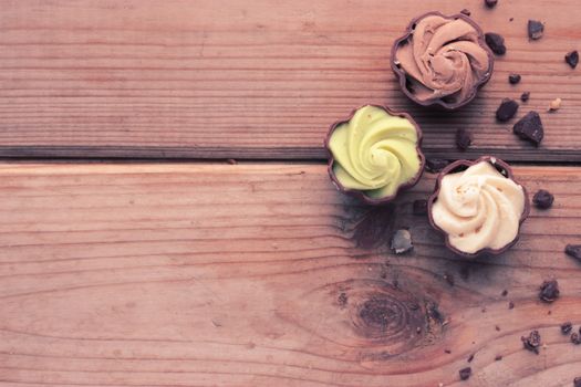 diffrent kinds of chocolate candy on wooden table