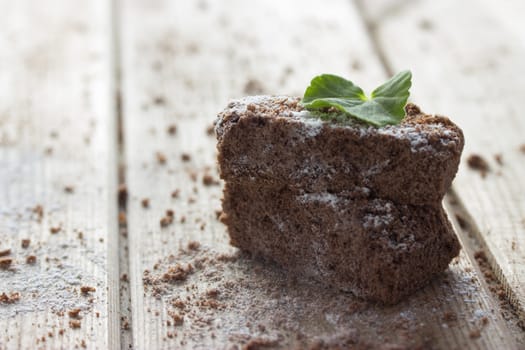 chocolate brownie and mint on wooden table