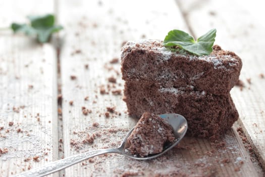 chocolate brownie and mint on wooden table