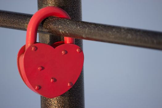 heart shaped padlock hang on the fence