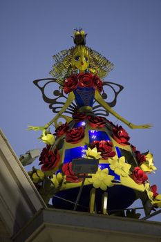 scary metal doll statue in colorful dress