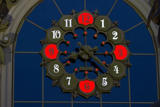 colorful illuminated clock with red numbers, night