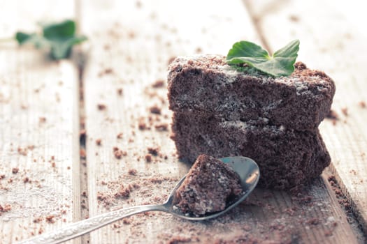 chocolate brownie and mint on wooden table