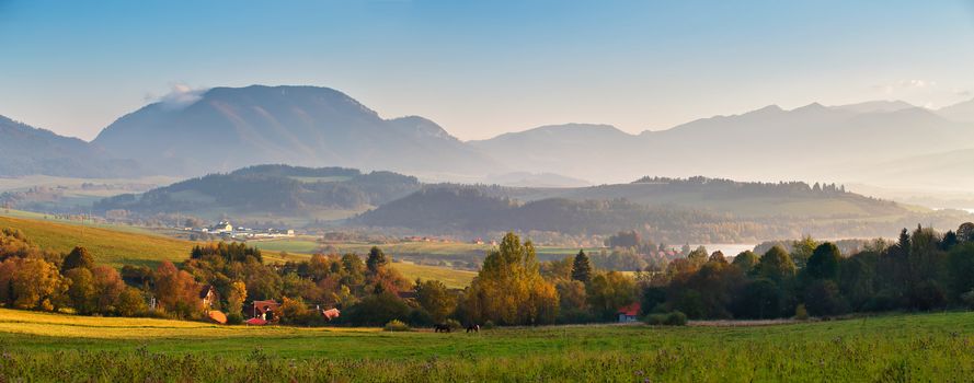 Slovakia autumn sunny morning panorama. Rural fall mountain scene. Village in valley.