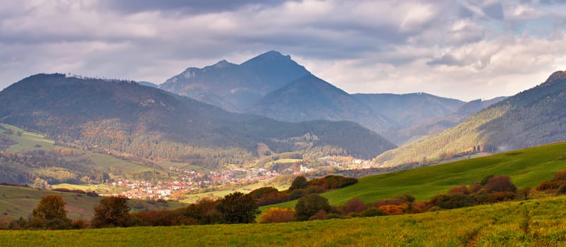 Slovakia autumn sunny morning panorama. Rural fall mountain scene. Village in valley.