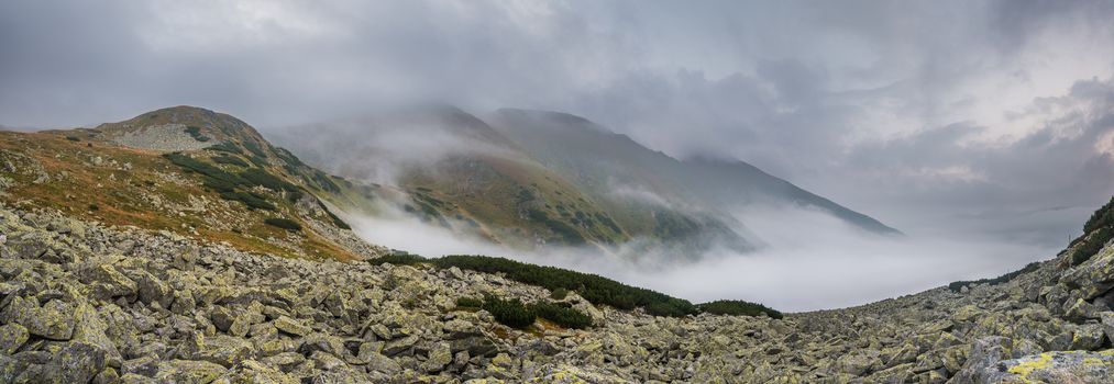 Mountains Landscape with Fog in Ziarska Valley. Rocks in Foreground.