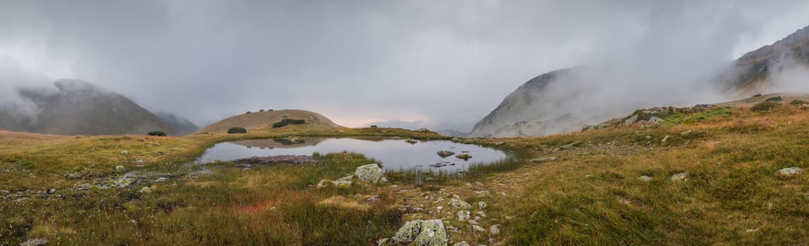 Wide Panoramic View of Small Tarn with Fog in West Tatra Mountains at Sunset