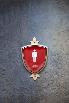 a men restroom sign on a concrete wall