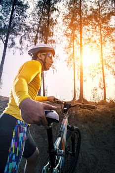 young man and mountain bicycle against sun light for people sport outdoor activity