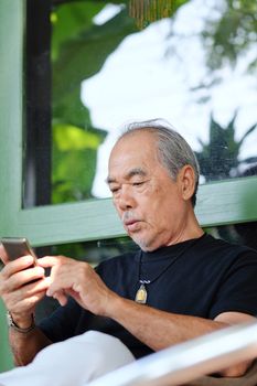 senior man enjoying on his phone