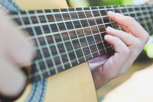 close up of playing acoustic guitar background