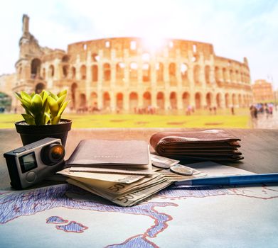 passport euro money bank note and action camera on wood table against colosseum scene background for rome italy traveling theme