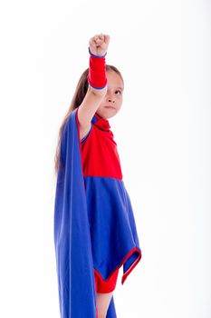 Girl in blue and red superhero costume holding arm up