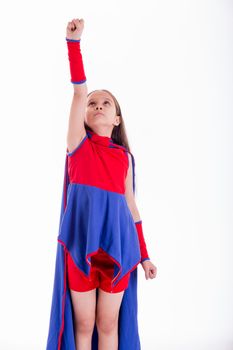 Girl in blue and red superhero costume holding arm up