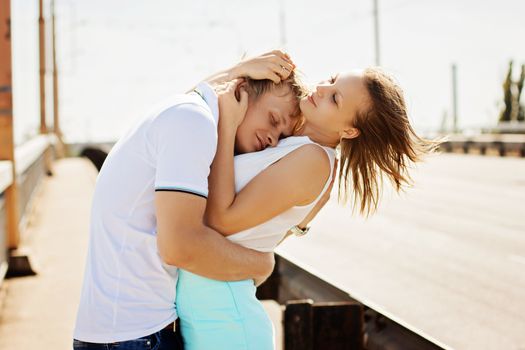 Man and woman kissing and embracing on the bridge. Couple in love