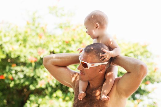 Portrait of happy father and his adorable little daughter outdoors.