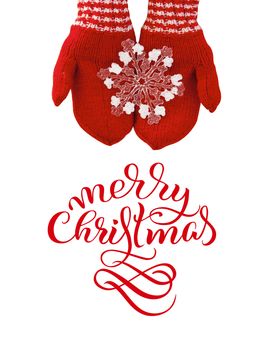 woman hands in red mittens hold a toy snowflake with text Merry Christmas. Lettering calligraphy.