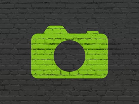Tourism concept: Painted green Photo Camera icon on Black Brick wall background