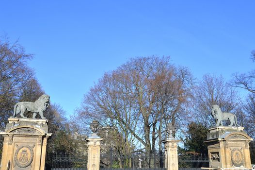 Two lions in sculpture on a pillar in front of a portico