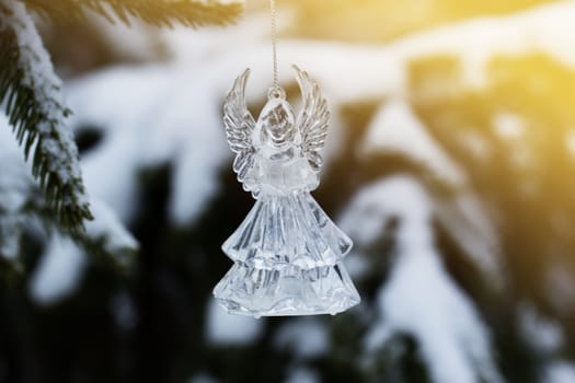 Christmas tree with snow and angel toy. Crystal Angel. new Year decoration.