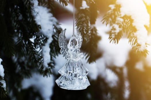 Christmas tree with snow and angel toy. Crystal Angel. new Year decoration.