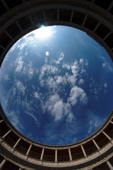 Fisheye view of sky above Palacio de Carlos V in Granada, spain