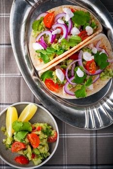 Chicken Tacos with vegetables served on the table.