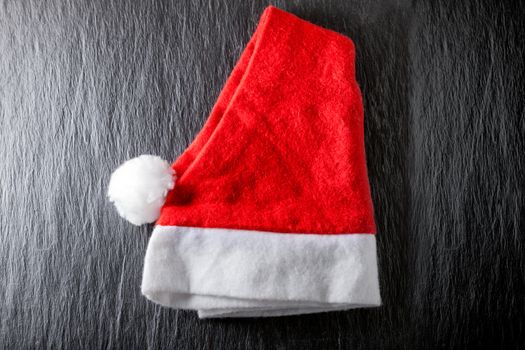 Red and white Santa's Hat on black background.