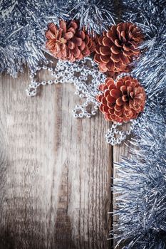 Home decor pine cones on a wooden background. 