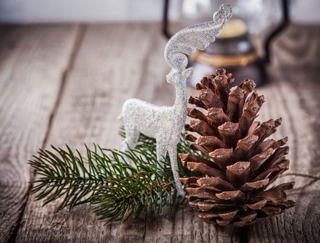 Christmas ornaments and old lamp on rustic wood.