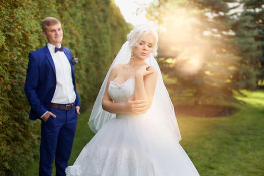 Stylish pair of newlyweds on a walk in the park