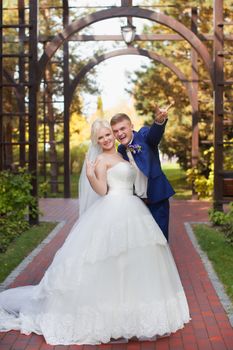 Happy couple just married in the alley in the park