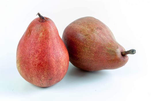 Ripe red pear fruits on white background