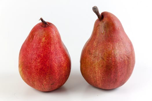 Ripe red pear fruits on white background