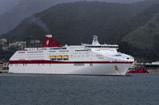 large white ship sailing in blue sea shore lengthwise